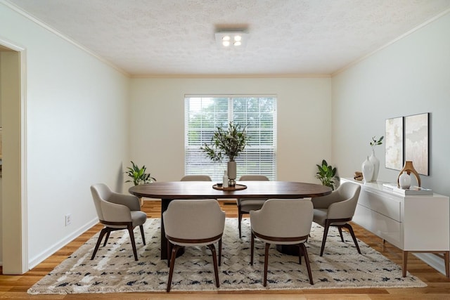 405 Parish Pl, Franklin, TN 37067 - dining room featuring a textured ceiling, crown molding, light wood-style floors, and baseboards