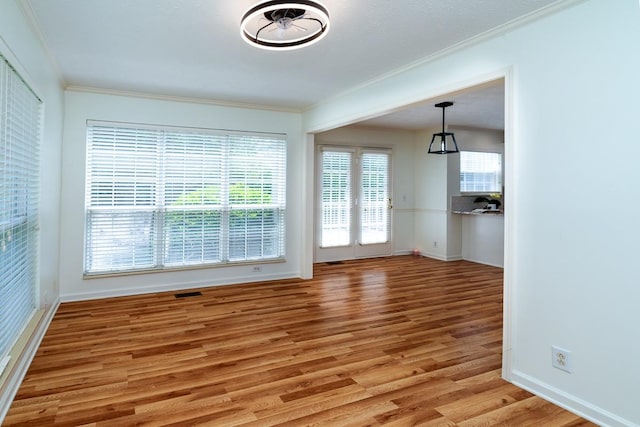405 Parish Pl, Franklin, TN 37067 - unfurnished dining area with light wood finished floors, crown molding, and baseboards