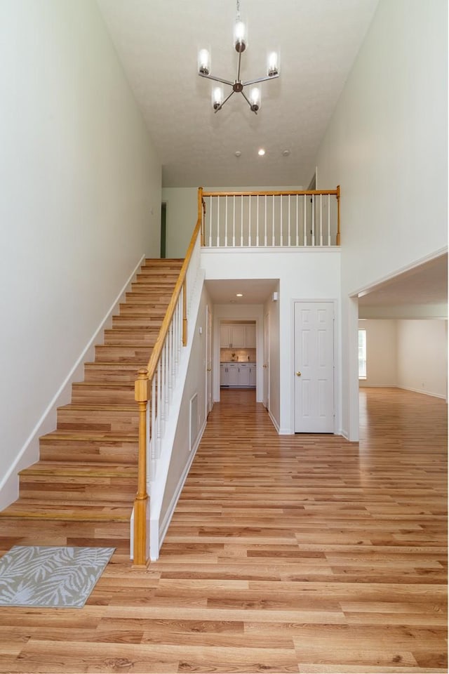 405 Parish Pl, Franklin, TN 37067 - stairs with a high ceiling, a chandelier, wood finished floors, baseboards, and recessed lighting