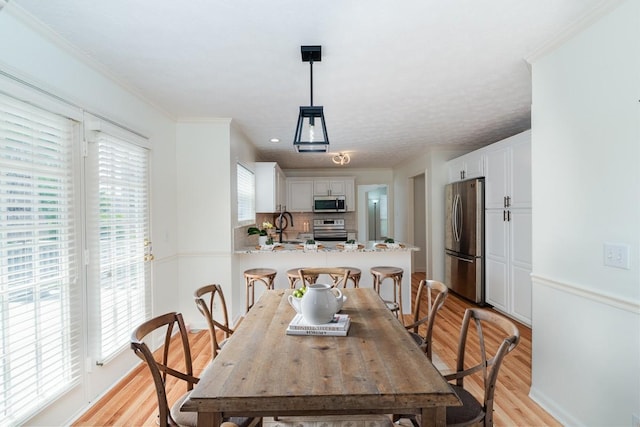 405 Parish Pl, Franklin, TN 37067 - dining area with light wood-type flooring and ornamental molding