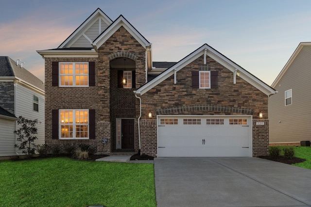 129 Willow Bend Dr, Mount Juliet, TN 37122 - view of front facade featuring concrete driveway, a yard, a garage, brick siding, and stone siding