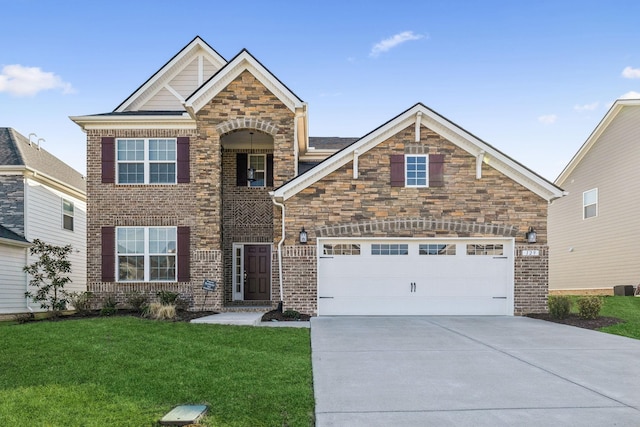 129 Willow Bend Dr, Mount Juliet, TN 37122 - view of front of house featuring a front lawn, concrete driveway, an attached garage, brick siding, and stone siding