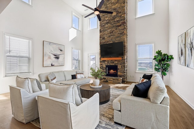 129 Willow Bend Dr, Mount Juliet, TN 37122 - living room with high vaulted ceiling, ceiling fan, wood finished floors, a stone fireplace, and baseboards