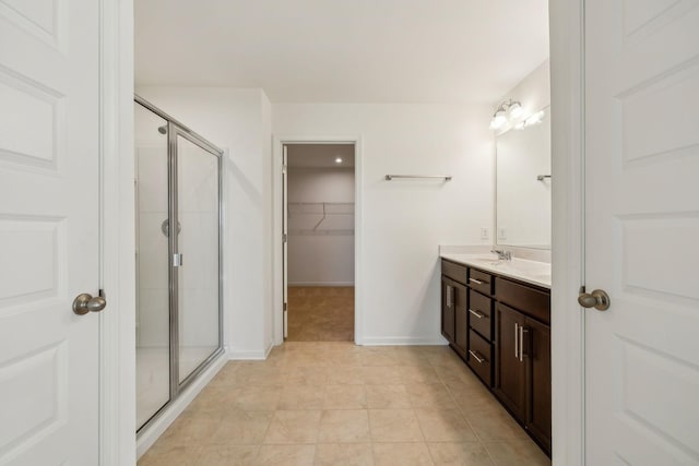 129 Willow Bend Dr, Mount Juliet, TN 37122 - full bathroom featuring double vanity, a stall shower, a spacious closet, baseboards, and tile patterned floors