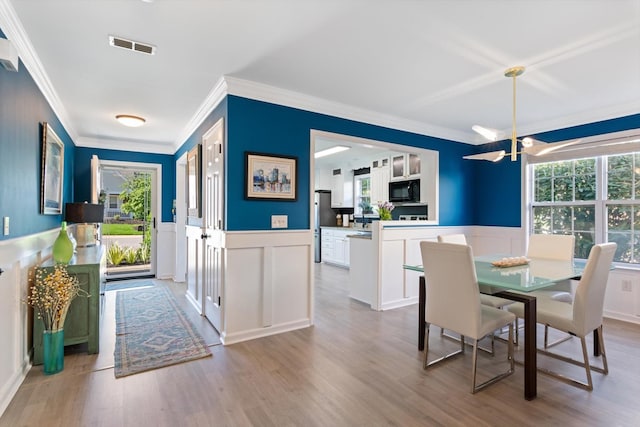 725 Forest Glen Cir, Murfreesboro, TN 37128 - dining room featuring crown molding, plenty of natural light, a decorative wall, a chandelier, and wainscoting