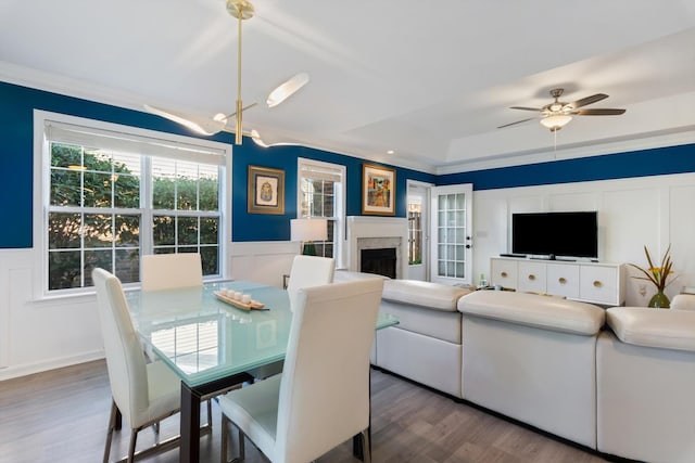 725 Forest Glen Cir, Murfreesboro, TN 37128 - dining room featuring wood finished floors, a ceiling fan, a fireplace, a decorative wall, and wainscoting