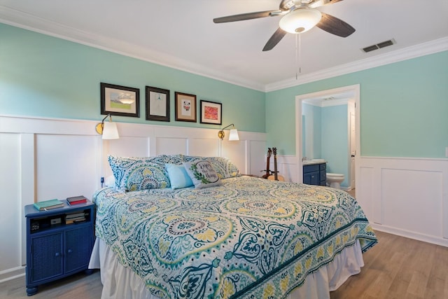 725 Forest Glen Cir, Murfreesboro, TN 37128 - bedroom featuring crown molding, wood finished floors, wainscoting, a decorative wall, and ceiling fan