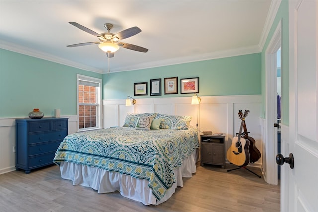 725 Forest Glen Cir, Murfreesboro, TN 37128 - bedroom featuring wainscoting, wood finished floors, crown molding, a decorative wall, and a ceiling fan