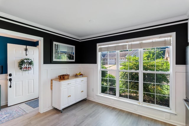 725 Forest Glen Cir, Murfreesboro, TN 37128 - doorway with crown molding, a wainscoted wall, light wood-type flooring, and a decorative wall