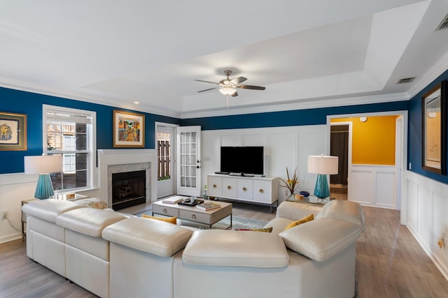 725 Forest Glen Cir, Murfreesboro, TN 37128 - living room featuring wood finished floors, a ceiling fan, crown molding, a decorative wall, and a raised ceiling