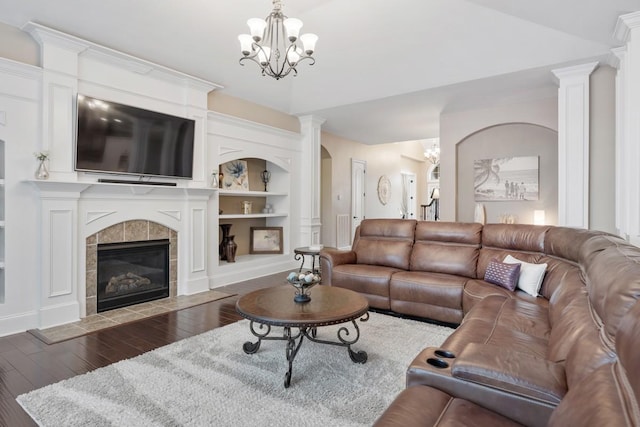 1237 Potter Ln, Gallatin, TN 37066 - living area with wood finished floors, a chandelier, built in shelves, a fireplace, and baseboards