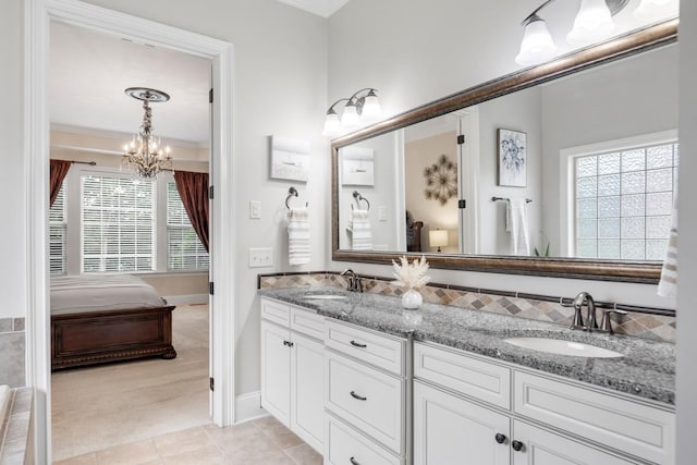 1237 Potter Ln, Gallatin, TN 37066 - ensuite bathroom featuring a chandelier, double vanity, tile patterned flooring, ornamental molding, and baseboards