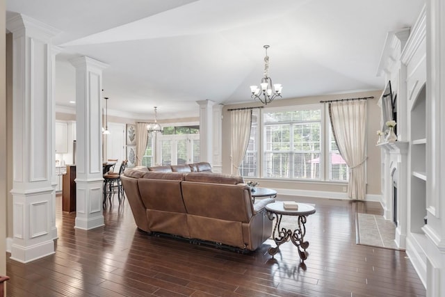 1237 Potter Ln, Gallatin, TN 37066 - living area with ornate columns, dark wood-style flooring, a fireplace with flush hearth, ornamental molding, and a chandelier