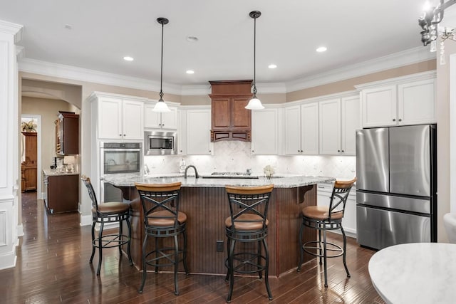 1237 Potter Ln, Gallatin, TN 37066 - kitchen with appliances with stainless steel finishes, dark wood-style floors, white cabinets, a kitchen island with sink, and crown molding