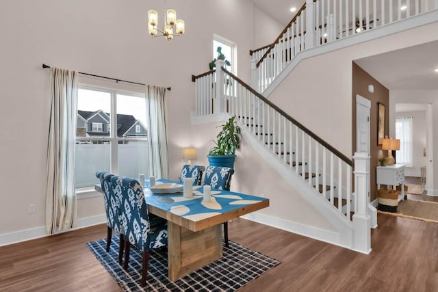 3608 Barbee Ct, Rockvale, TN 37153 - dining room with a chandelier, wood finished floors, stairs, a towering ceiling, and healthy amount of natural light