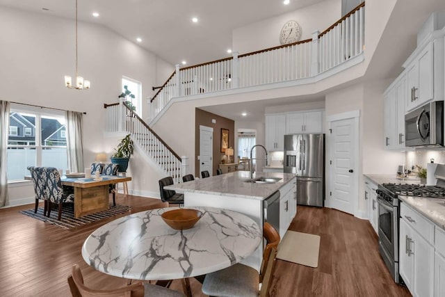 3608 Barbee Ct, Rockvale, TN 37153 - kitchen featuring stainless steel appliances, a sink, a high ceiling, dark wood-style flooring, and an island with sink