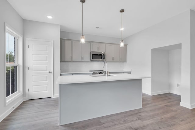 130 Beignet Aly, Hendersonville, TN 37075 - kitchen featuring stainless steel microwave, gray cabinetry, light countertops, tasteful backsplash, and a sink