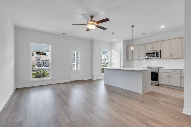 126 Beignet Aly, Hendersonville, TN 37075 - kitchen featuring stainless steel appliances, ceiling fan, backsplash, light countertops, and baseboards
