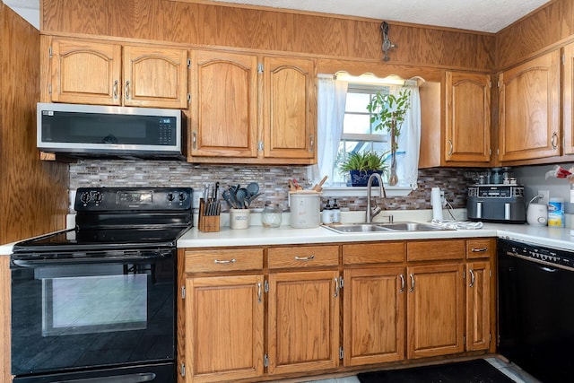 5024 Short Mountain Hwy, Smithville, TN 37166 - kitchen featuring black appliances, a sink, backsplash, light countertops, and brown cabinetry