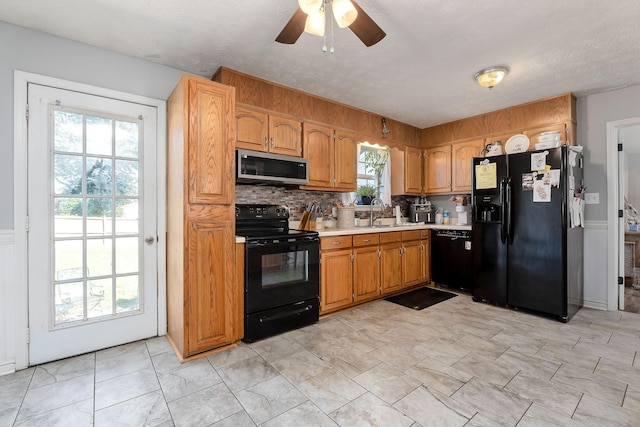 5024 Short Mountain Hwy, Smithville, TN 37166 - kitchen featuring black appliances, light countertops, a ceiling fan, a sink, and brown cabinetry