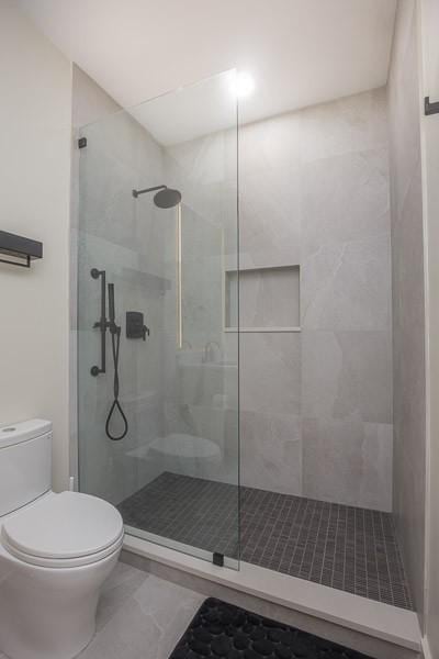1030 17th Ave S Unit 201, Nashville, TN 37212 - full bath with toilet, a shower stall, and tile patterned floors