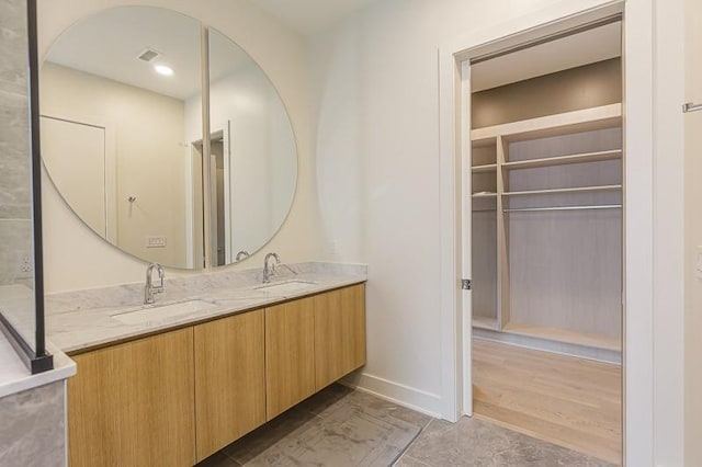 1030 17th Ave S Unit 201, Nashville, TN 37212 - full bathroom featuring double vanity and baseboards