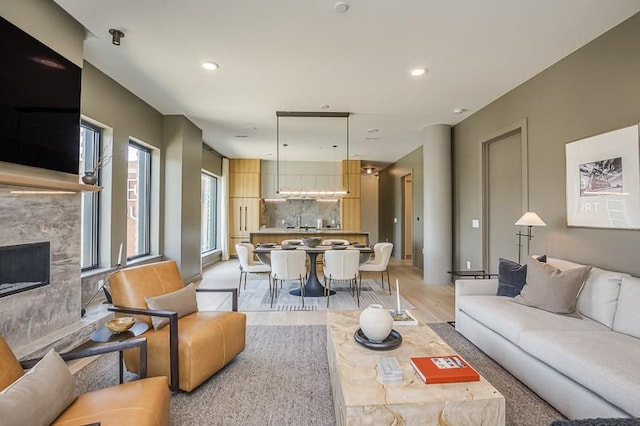 1030 17th Ave S Unit 201, Nashville, TN 37212 - living room featuring light wood-style floors, a premium fireplace, and recessed lighting