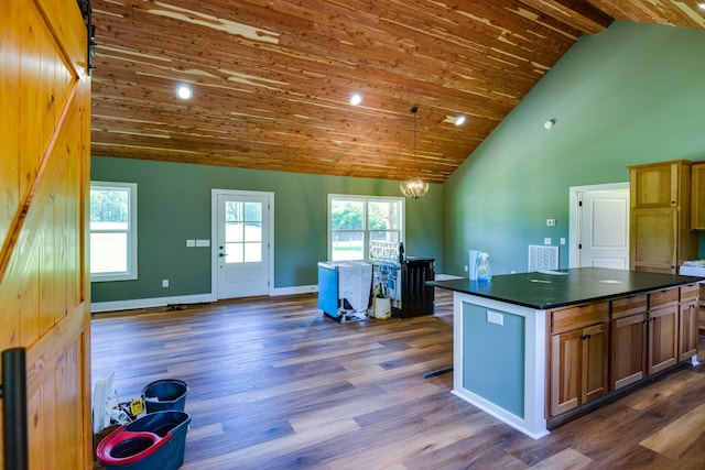 1474 Pea Ridge Rd, Manchester, TN 37355 - kitchen featuring dark countertops, high vaulted ceiling, dark wood finished floors, a center island, and baseboards