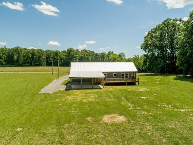 1474 Pea Ridge Rd, Manchester, TN 37355 - back of house featuring dirt driveway, a lawn, metal roof, and a carport