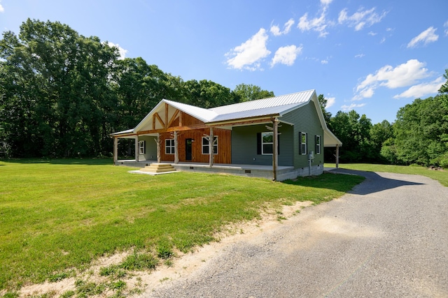 1474 Pea Ridge Rd, Manchester, TN 37355 - view of front of property featuring a porch, dirt driveway, a front yard, metal roof, and crawl space