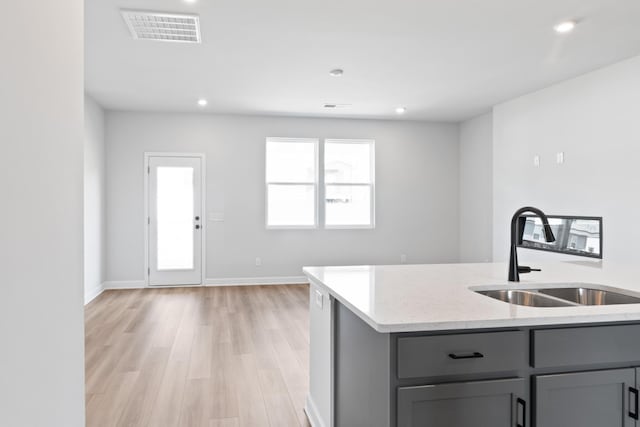 283 Subban Ct, Lebanon, TN 37087 - kitchen featuring gray cabinetry, a sink, light stone countertops, light wood-type flooring, and recessed lighting