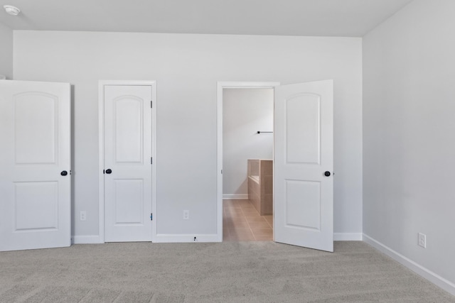 283 Subban Ct, Lebanon, TN 37087 - unfurnished bedroom featuring carpet, baseboards, ensuite bathroom, and tile patterned flooring
