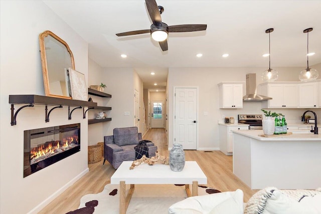 3670 Main St Unit 5, Jasper, TN 37347 - living area featuring light wood-style flooring, a glass covered fireplace, ceiling fan, baseboards, and recessed lighting