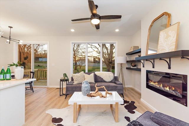 3670 Main St Unit 1, Jasper, TN 37347 - living area featuring light wood-type flooring, a glass covered fireplace, ceiling fan, baseboards, and recessed lighting