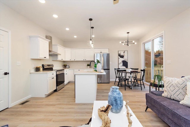 3670 Main St Unit 1, Jasper, TN 37347 - kitchen with appliances with stainless steel finishes, wall chimney exhaust hood, recessed lighting, light wood-type flooring, and light countertops