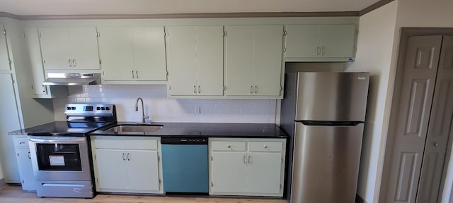 2000 Hickory Hill Ln, Hermitage, TN 37076 - kitchen featuring appliances with stainless steel finishes, a sink, under cabinet range hood, backsplash, and dark countertops