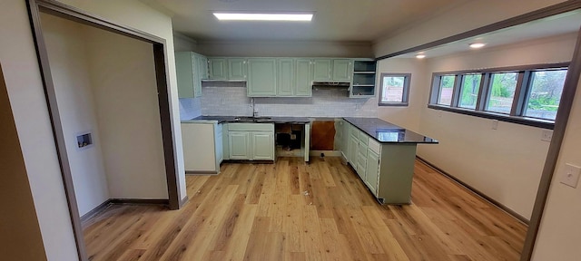 2000 Hickory Hill Ln, Hermitage, TN 37076 - kitchen featuring decorative backsplash, light wood finished floors, a sink, baseboards, and crown molding
