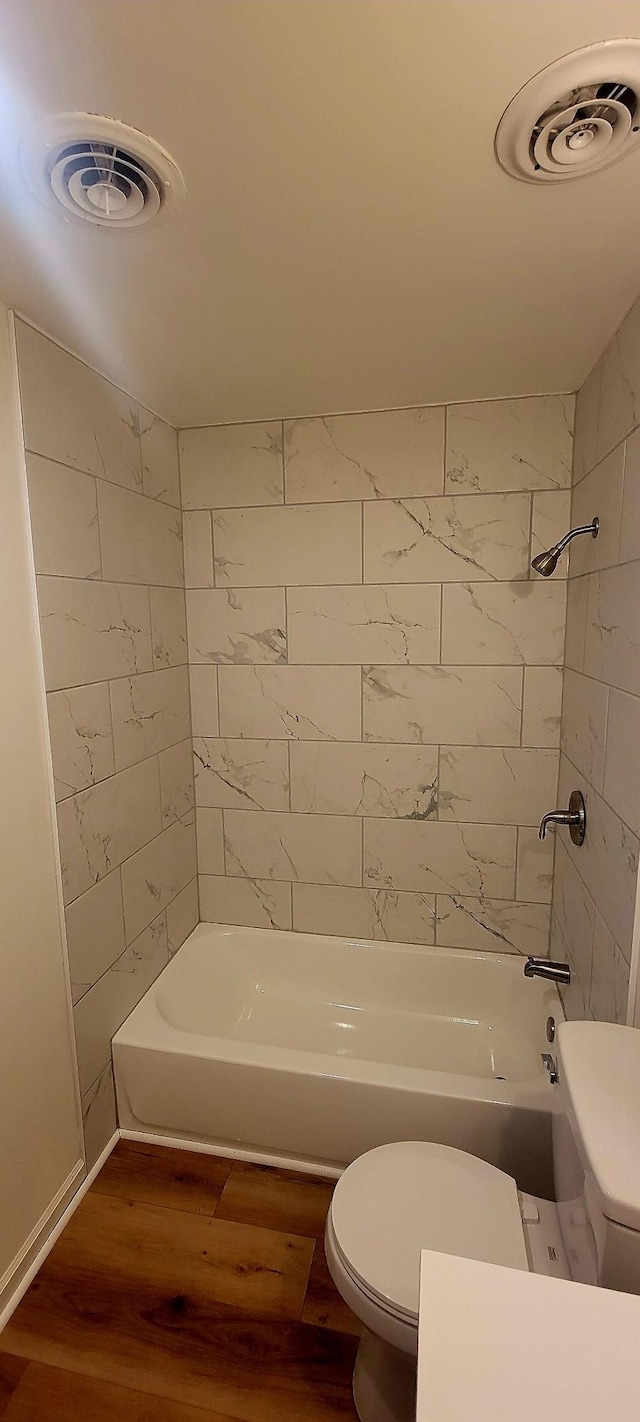 2000 Hickory Hill Ln, Hermitage, TN 37076 - bathroom with toilet, wood finished floors, and bathing tub / shower combination