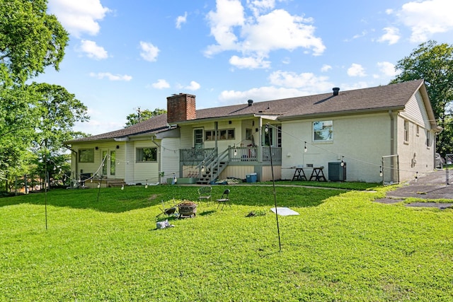 2000 Hickory Hill Ln, Hermitage, TN 37076 - rear view of property with a chimney, an outdoor fire pit, cooling unit, a lawn, and roof with shingles