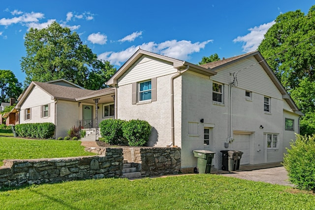 2000 Hickory Hill Ln, Hermitage, TN 37076 - view of side of home with brick siding, driveway, a lawn, and an attached garage