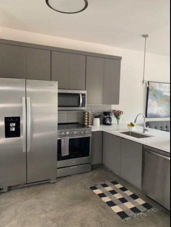 2521 Clifton Ave Unit 101, Nashville, TN 37209 - kitchen featuring stainless steel appliances, gray cabinets, concrete flooring, and a sink