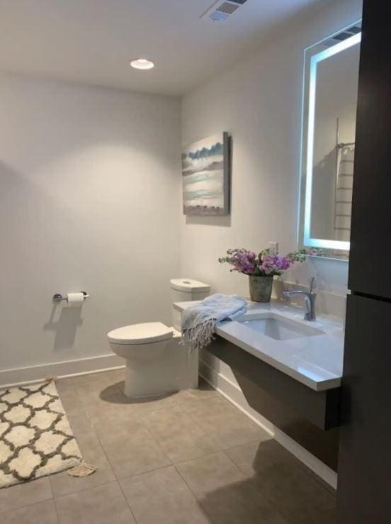2521 Clifton Ave Unit 101, Nashville, TN 37209 - bathroom featuring toilet, tile patterned flooring, vanity, baseboards, and recessed lighting