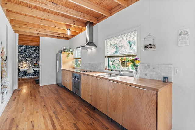 4303 Burrus St, Nashville, TN 37216 - kitchen with wall chimney range hood, stainless steel appliances, wood ceiling with exposed beams, tasteful backsplash, and a sink