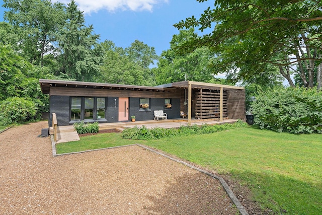 4303 Burrus St, Nashville, TN 37216 - back of house featuring a yard and brick siding