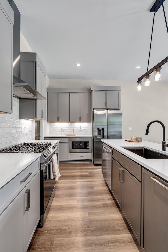 1004 Noble Loop Unit 49, Nashville, TN 37211 - kitchen with a sink, stainless steel appliances, wall chimney exhaust hood, recessed lighting, and backsplash