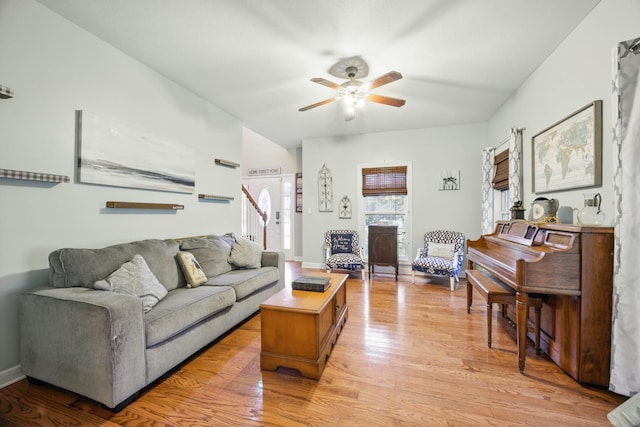 3198 Gray Hawk Ct, Clarksville, TN 37043 - living room featuring a ceiling fan, light wood-style flooring, and stairs