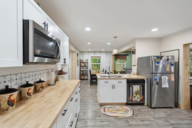 1602 Pleasant Grove Rd, Westmoreland, TN 37186 - kitchen featuring appliances with stainless steel finishes, wooden counters, light wood finished floors, white cabinets, and recessed lighting