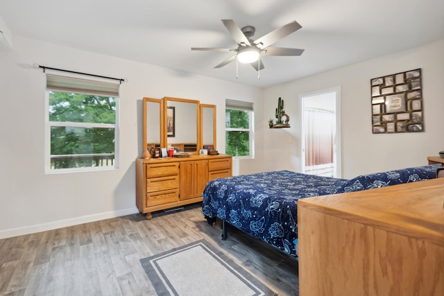 1602 Pleasant Grove Rd, Westmoreland, TN 37186 - bedroom featuring light wood-style floors, multiple windows, baseboards, and ceiling fan