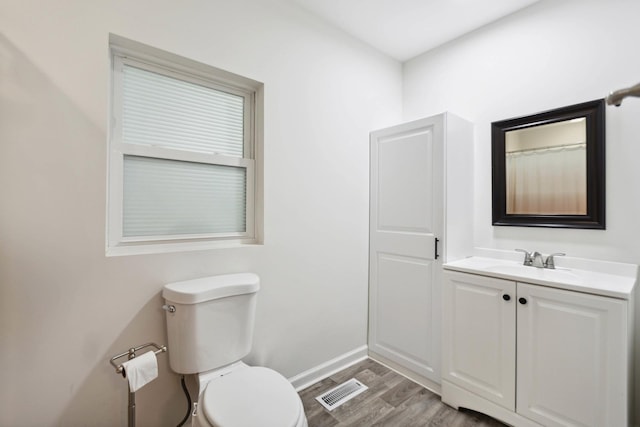 1602 Pleasant Grove Rd, Westmoreland, TN 37186 - bathroom with toilet, vanity, wood finished floors, and baseboards