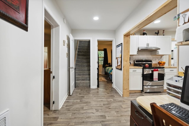 1602 Pleasant Grove Rd, Westmoreland, TN 37186 - kitchen with stainless steel range with electric stovetop, under cabinet range hood, light wood finished floors, recessed lighting, and white cabinets